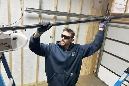 installation-hero+(1)+(1) Technician installing garage door inside workshop.